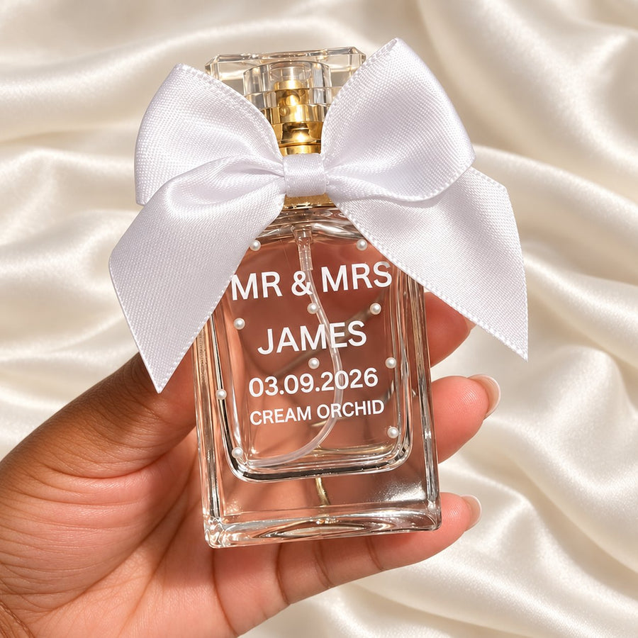30ml Square Perfume Wedding Favours held in a neatly manicured hand on ivory satin