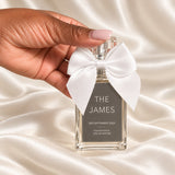 30ml Plaque Perfume Wedding Favours held in a neatly manicured hand on ivory satin