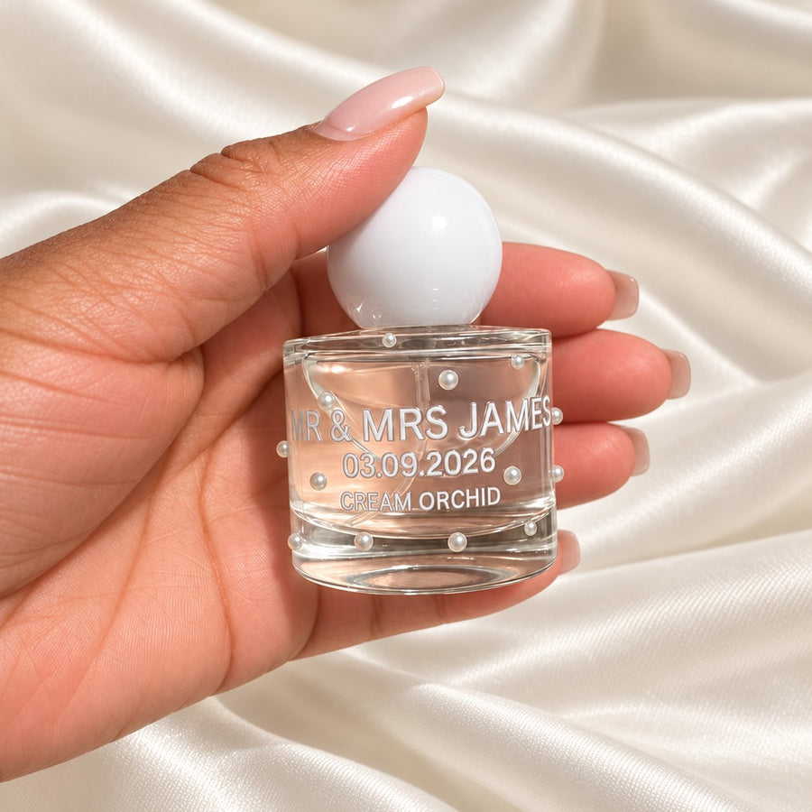 30ml Round Perfume Wedding Favours held in a neatly manicured hand on ivory satin