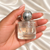Personalised Bridesmaid Proposal Perfume held in a neatly manicured hand on ivory satin