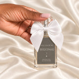 Personalised Bridesmaid Proposal Perfume held in a neatly manicured hand on ivory satin