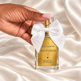 Personalised Maid of Honour Proposal Perfume held in a neatly manicured hand on ivory satin