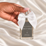 Personalised Maid of Honour Proposal Perfume held in a neatly manicured hand on ivory satin