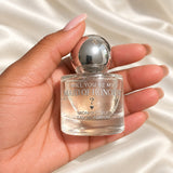 Personalised Maid of Honour Proposal Perfume held in a neatly manicured hand on ivory satin